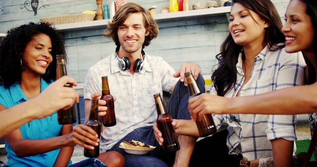 Group of Happy Friends at a Party Drinking Beers and Smiling - Download Free Stock Photos Pikwizard.com