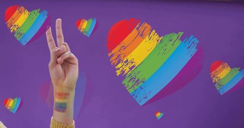 Peace sign with rainbow forearm and brushstroke hearts on purple background for pride