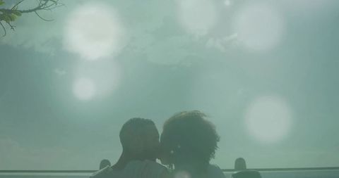 Silhouetted Couple Embracing on Rooftop at Twilight