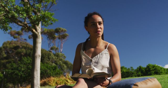 Woman Reading Book Outdoors Under Sunny Blue Sky - Download Free Stock Images Pikwizard.com