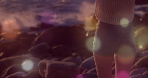 Woman Enjoying Beach at Sunset with Light Bokeh Effects