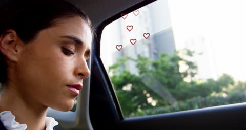 Caucasian Woman Smiling in Car with Heart Icons