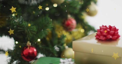 Holiday Decorations and Gifts by Christmas Tree with Sparkling Stars