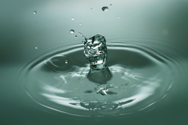 Close-up of Drop Splashing in Water - Download Free Stock Photos Pikwizard.com