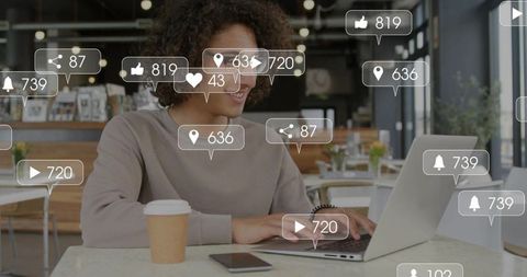 Working remotely in cafe with laptop and smartphone and floating social media notifications