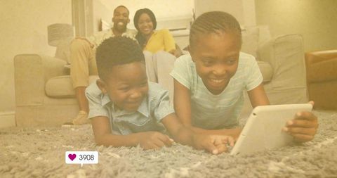 Children Enjoying Tablet Time on Cozy Rug with Happy Parents Nearby
