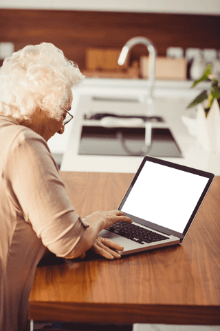 elderly woman engaging with transparent laptop in home setting - Download Free Stock Videos Pikwizard.com