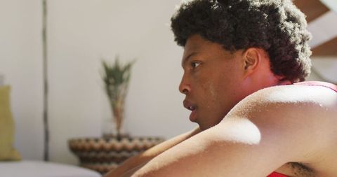 Focused african american man resting after intense workout at home