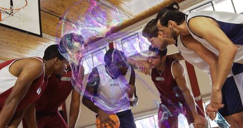 Basketball Team Strategy Huddle in Overhead Gym Setting