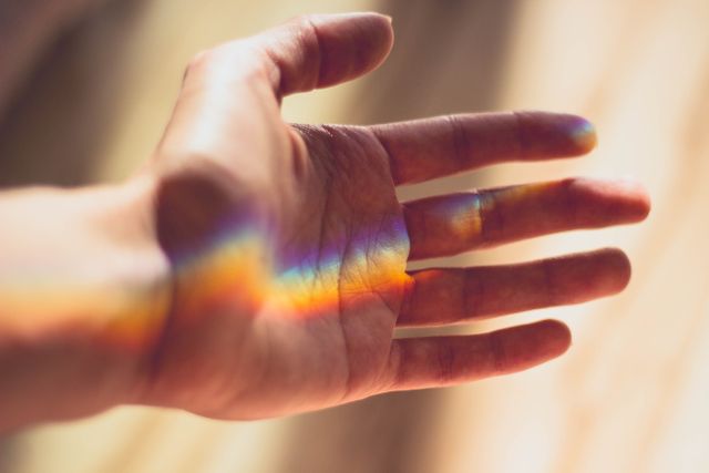 Hand with Rainbow Light Reflection in Soft Focus - Download Free Stock Photos Pikwizard.com