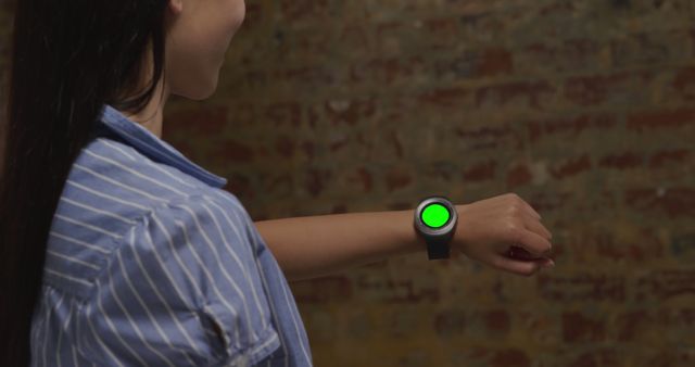 Woman Using Smartwatch with Green Screen for Customization - Download Free Stock Images Pikwizard.com