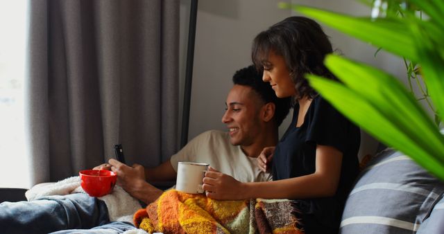 Couple enjoying cozy morning with coffee on bed - Download Free Stock Images Pikwizard.com