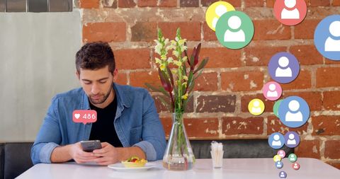 Young man engaging on social media at cafe table