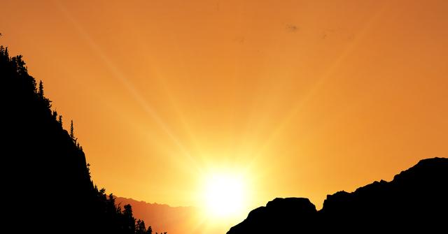 Silhouette mountains with sun shining in background - Download Free Stock Photos Pikwizard.com
