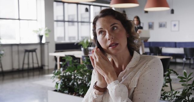 Businesswoman Taking Phone Call in Modern Office - Download Free Stock Images Pikwizard.com