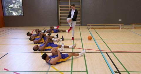 Diverse Basketball Team Stretching During Pre-Game Routine