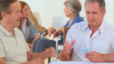 Senior Friends Enjoying Card Game in Nursing Home