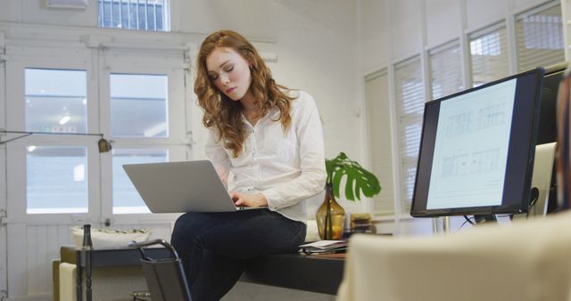 Young Woman Using Laptop in Modern Office Workspace - Download Free Stock Images Pikwizard.com