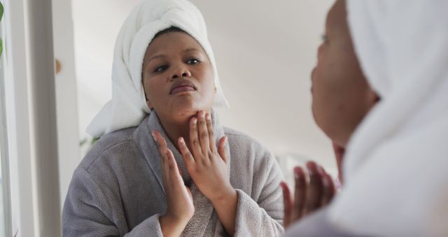 Woman With Towel on Head Checking Skin in Bathroom Mirror - Download Free Stock Images Pikwizard.com