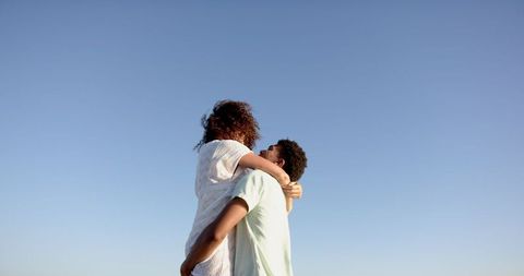 Romantic Couple Embracing Under Clear Sky