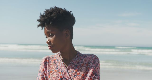 Thoughtful Woman with Afro Hairstyle by the Beach on a Sunny Day - Download Free Stock Images Pikwizard.com