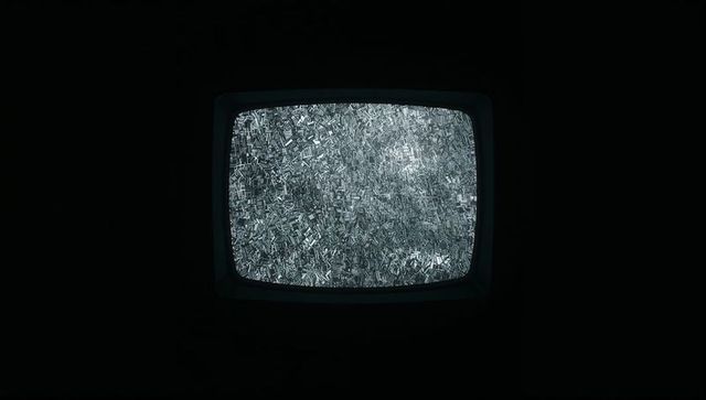 Retro CRT Television Display Showing Dense Monochrome Static With Glowing Grainy Noise
