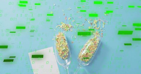 Digital confetti scattering in champagne flutes with green binary code overlay