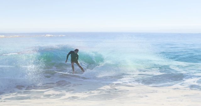 Image of landscape with ocean over caucasian male surfer surfing. ocean day and celebration concept digitally generated image.