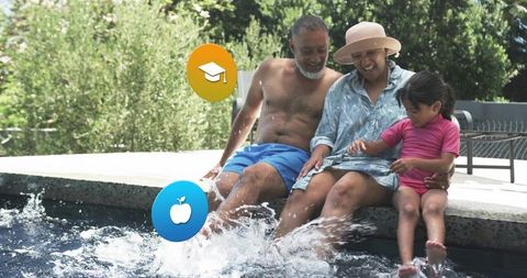 Multigenerational family splashing pool water with feet, sun hat and overlay icons