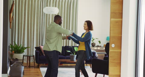 Joyful Multicultural Couple Dancing at Home