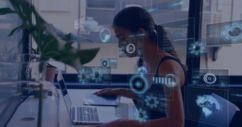 Typing woman interacting with holographic UI overlays on laptop in minimalist urban office