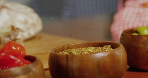 Rustic wooden bowls holding wholegrain mustard with peppers and olives on board