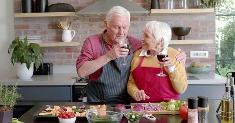 Elderly Couple Enjoying Wine and Cooking Together at Home - Download Free Stock Images Pikwizard.com