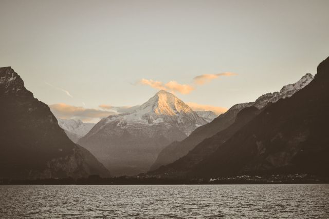 Picturesque Snow-Capped Mountain Range at Sunrise over Smooth Lake - Download Free Stock Photos Pikwizard.com