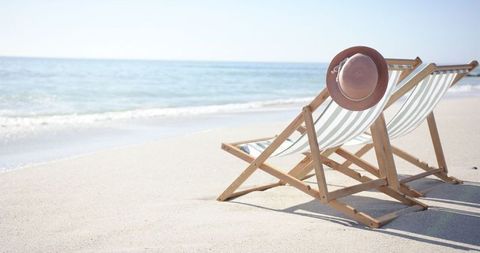 Tranquil Beach Retreat with Deckchair and Summer Hat