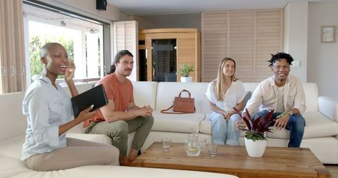 Friends Enjoying Leisure Time on Sofa at Home