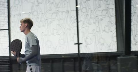 Sportsman Holding Paddle Racket on Modern Padel Court