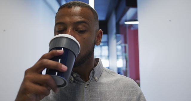 Businessman Drinking Coffee in Modern Office Hallway - Download Free Stock Images Pikwizard.com