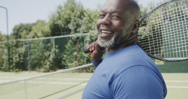 Senior Man Smiling on Tennis Court Holding Racket - Download Free Stock Images Pikwizard.com