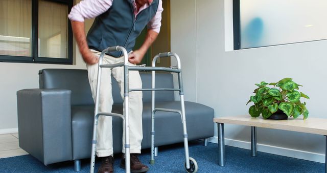 Senior man using walker for support in living room - Download Free Stock Images Pikwizard.com