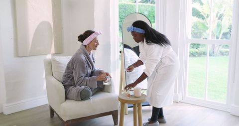 Diverse women enjoying spa day with manicure rituals at home
