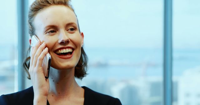 Smiling Businesswoman on Phone Call with City View Background - Download Free Stock Images Pikwizard.com