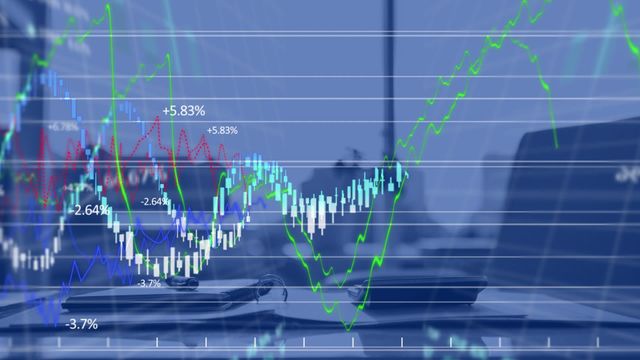 Animated graphs and charts superimposed over an office desk symbolize analysis and monitoring of financial data. Suitable for content related to business finance, stock market analysis, data-driven decision making, or financial technology marketing materials.