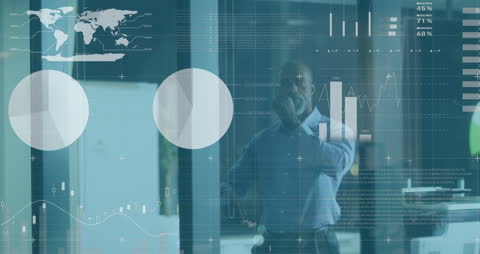 Businessman in Office Analyzing Financial Graphs and Data