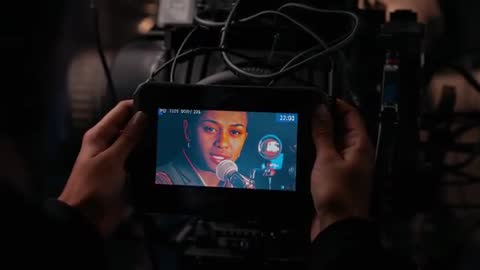 Operator Holding Monitor Reviewing Vocalist Singing into Retro Microphone with Timecode