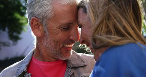 Mature Couple Embracing Outdoors with Smiles