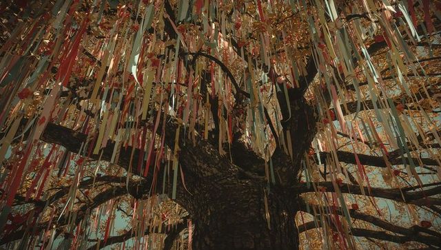 Tree with colorful ribbons and paper tags in festival theme