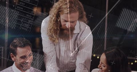 Manager leaning over glass table leading collaborative strategy session with data overlays