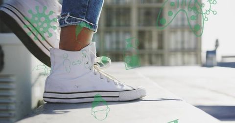 Resting white high-top sneaker on rooftop ledge with frayed jeans and germ doodles