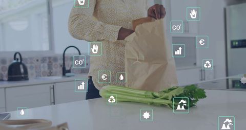 this image depicts a biracial woman unpacking groceries in a modern kitchen with overlaid eco icons. the presence of digital symbols indicates concepts of sustainability, carbon footprint, and green living. ideal for illustrating articles or advertising campaigns on environmental consciousness, sustainable dining, or technological advancements in eco-friendly practices.